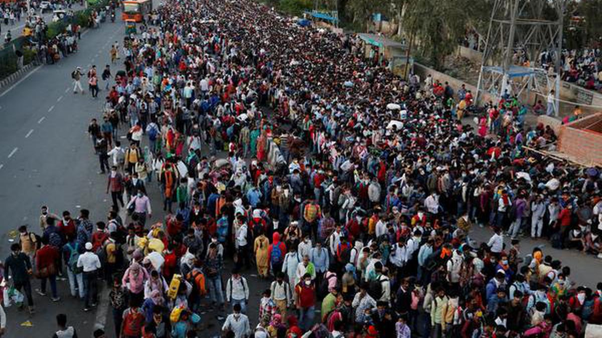 Large number of people mostly migrants gathered at bus stands after Delhi imposed weeklong lockdown to contain spread of coronavirus cases.